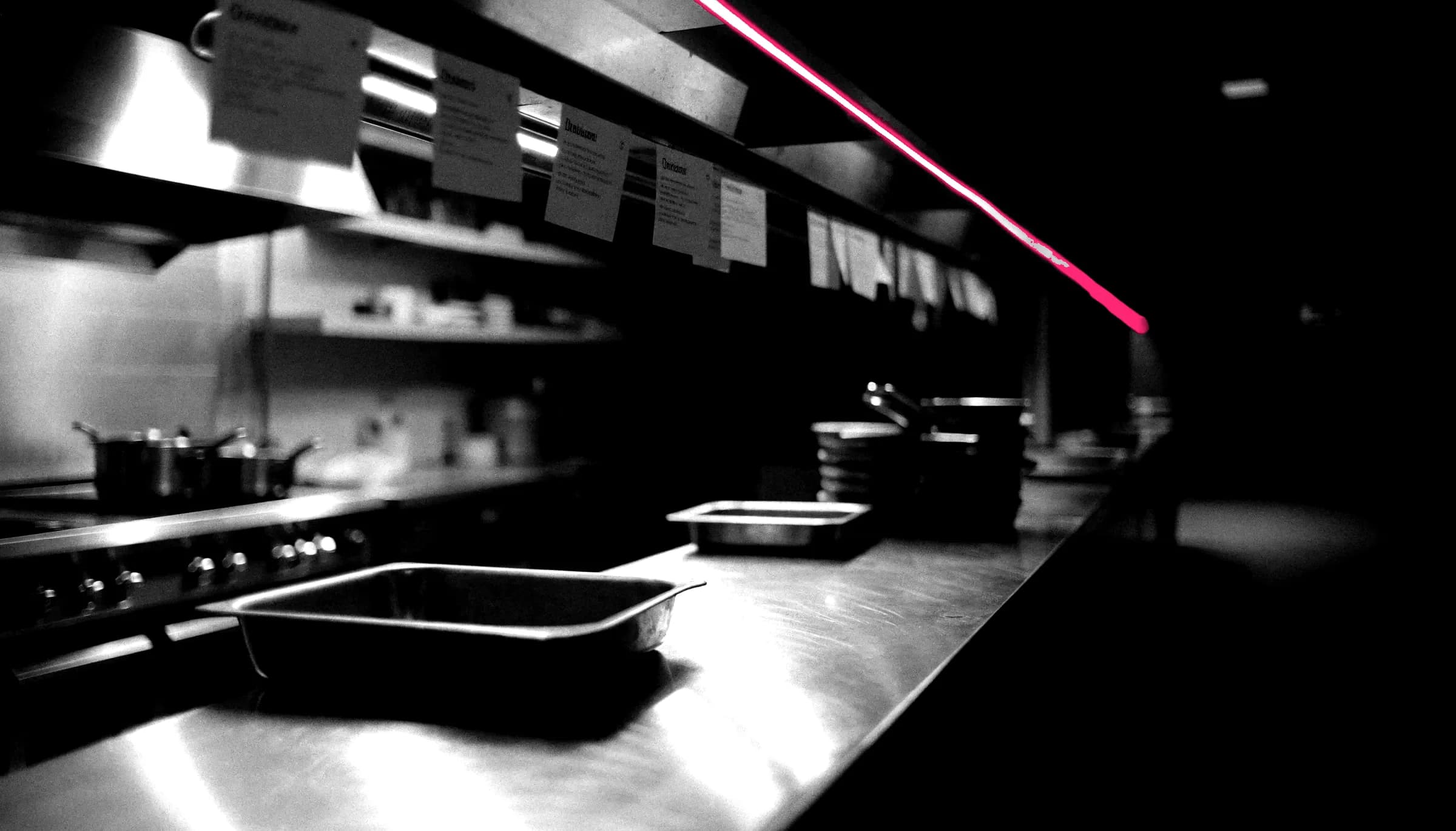 An empty restaurant pass at night, lit by a single line of light