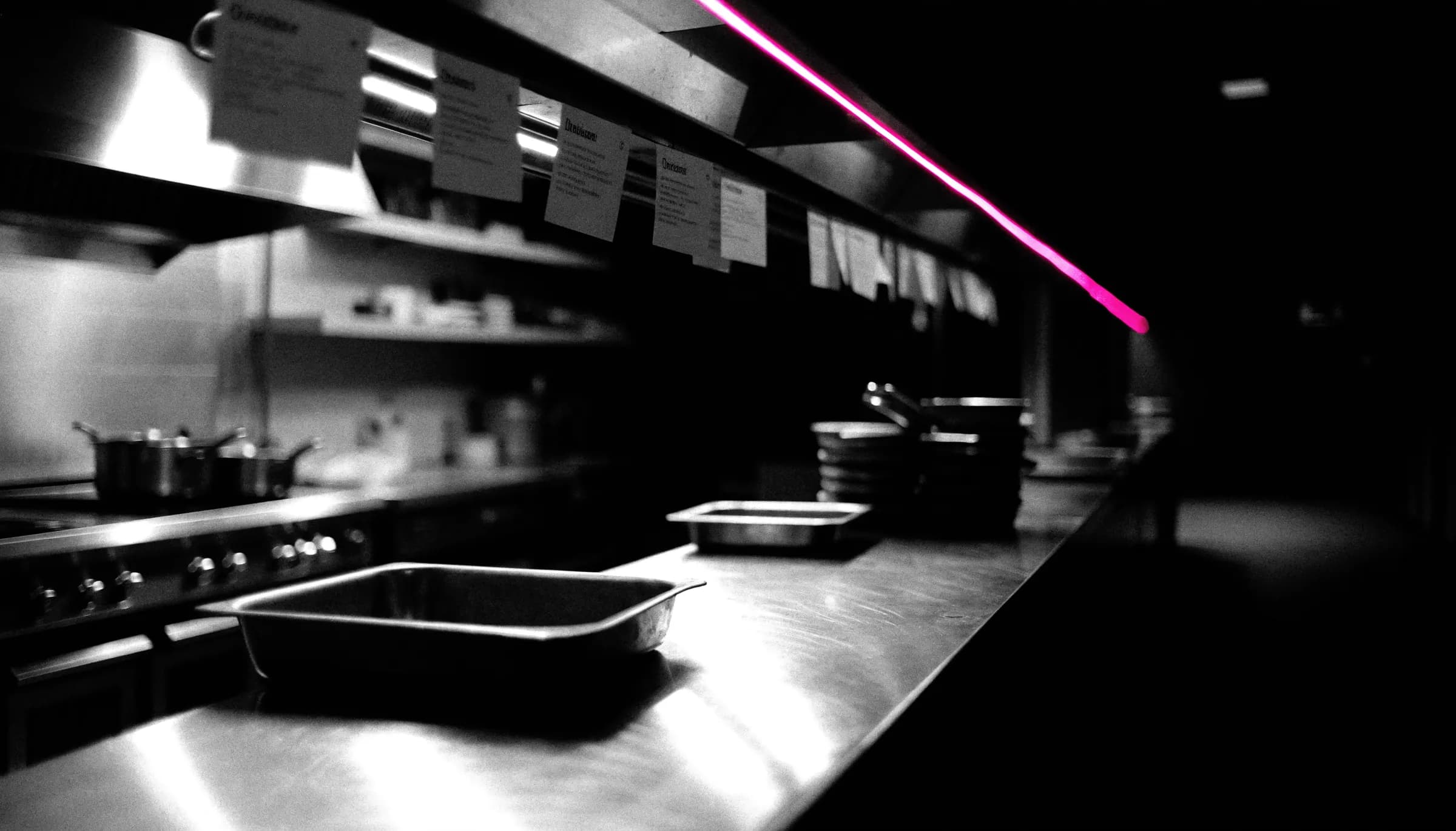 An empty restaurant pass at night, lit by a single line of light
